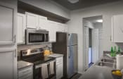 Thumbnail 5 of 26 - a kitchen with white cabinets and stainless steel appliances