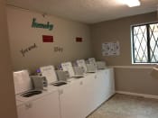 Thumbnail 7 of 8 - a laundry room with four washers and four dryers