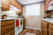 Thumbnail 2 of 26 - a kitchen with wood cabinets and white appliances