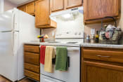 Thumbnail 3 of 26 - a kitchen with white appliances and wooden cabinets