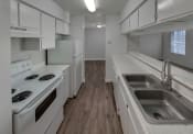 Thumbnail 8 of 19 - a kitchen with white appliances and white cabinets
