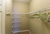 Thumbnail 5 of 15 - a walk in closet with shelves and a mirrored closet door