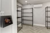 Thumbnail 30 of 30 - a walk in closet with shelving and a television