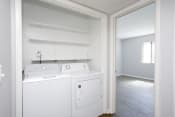 Thumbnail 9 of 30 - a laundry room with a washer and dryer