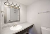 Thumbnail 5 of 30 - a bathroom with a sink and mirror