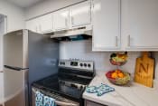 Thumbnail 1 of 19 - a kitchen with stainless steel appliances and white cabinets