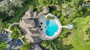 Thumbnail 28 of 41 - a backyard pool with a pool house and a swimming pool