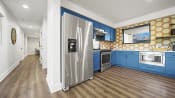 Thumbnail 8 of 44 - a kitchen with blue cabinets and stainless steel appliances