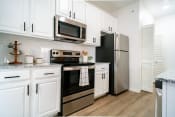 Thumbnail 7 of 42 - a kitchen with stainless steel appliances and white cabinets