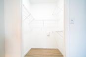 Thumbnail 13 of 42 - a white room with a wood floor and a white door