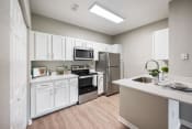 Thumbnail 1 of 41 - an open kitchen with stainless steel appliances and white cabinets