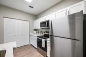 Thumbnail 2 of 41 - a kitchen with stainless steel appliances and white cabinets