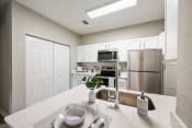 Thumbnail 3 of 41 - a kitchen with stainless steel appliances and white cabinets