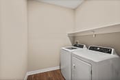 Thumbnail 9 of 25 - a washer and dryer in a laundry room at the oxford at estonia apartments