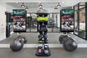 Thumbnail 21 of 48 - a robot in a gym with weights and other exercise equipment