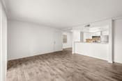 Thumbnail 6 of 29 - an empty living room and kitchen with wood flooring