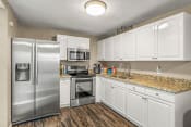 Thumbnail 1 of 29 - a kitchen with stainless steel appliances and white cabinets
