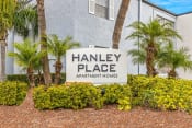 Thumbnail 29 of 29 - a sign for hanley place apartments in front of palm trees