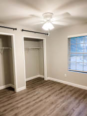 Thumbnail 13 of 19 - an empty bedroom with a closet and a ceiling fan