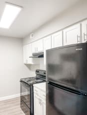 Thumbnail 4 of 19 - a kitchen with stainless steel appliances and white cabinets