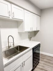 Thumbnail 3 of 19 - an empty kitchen with white cabinets and a sink