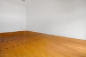 Thumbnail 9 of 22 - an empty room with wooden floors and a white wall