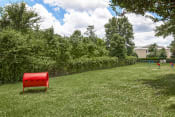 Thumbnail 16 of 22 - a red chair sitting in the middle of a field