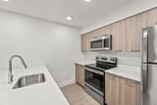 Thumbnail 1 of 24 - a kitchen with white countertops and wooden cabinets