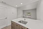 Thumbnail 8 of 24 - the kitchen of our studio apartment atrium with white countertops and a sink