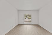 Thumbnail 3 of 24 - an empty living room with a door to a driveway