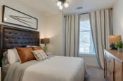 Thumbnail 7 of 32 - Model Bedroom with Bed and Nightstands and Large Window at Hermosa Village, Leander, TX