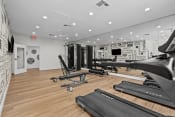 Thumbnail 19 of 24 - the gym with treadmills and other exercise equipment in a room with white walls
