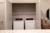 Thumbnail 10 of 30 - two washers and dryers in a laundry room