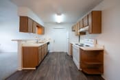 Thumbnail 31 of 37 - a kitchen with wood flooring and white appliances