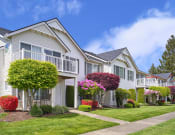 Thumbnail 21 of 38 - One BR Apartments in Dupont, WA - Clock Tower Village - Apartment Building Exterior with Gorgeous Landscaping, and Sidewalks
