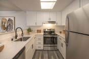 Thumbnail 1 of 39 - Apartments for Rent in Citrus Heights - The Arlo in Citrus Heights - Modern Kitchen with Stainless-Steel Appliances and White Cabinetry
