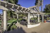 Thumbnail 23 of 28 - a seating area under a white pergola in a garden