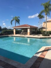 Thumbnail 15 of 19 - Pool with lounge chairs Golden Lakes Apartments Miami Florida