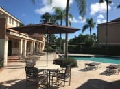 Thumbnail 17 of 19 - Seating by the pool Golden Lakes Apartments Miami Florida