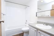 Thumbnail 7 of 7 - Apartments in Des Moines for Rent - Marina Club - Bathroom with Granite-Style Countertop, Plank-Wood Floors, and Shower with Bathtub Combo