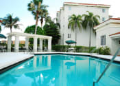 Thumbnail 3 of 13 - Pool with lounge chairs Heron Pointe Apartments Miramar Florida
