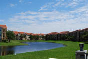 Thumbnail 3 of 15 - Renaissance community exterior with palm trees and lake views