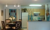 Thumbnail 8 of 13 - Mariners cove apartment home kitchen space with white appliances and blonde colored cabinetry
