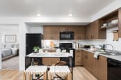 Thumbnail 15 of 22 - a kitchen in a 555 waverly unit with a table and two stools in the