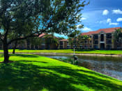 Thumbnail 4 of 15 - Renaissance community exterior with palm trees and lake