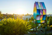 Thumbnail 70 of 81 - a person walking past a colorful sculpture in a park