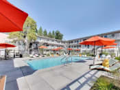 Thumbnail 26 of 26 - The Post Apartments pool area with umbrellas and lounge seating