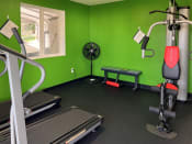Thumbnail 28 of 28 - Apartments for Rent in Sherwood, Or - Township Sherwood - Black Floorings, Green Painted Walls, Gym Equipment, and Corner Fan
