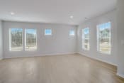 Thumbnail 16 of 19 - an empty living room with a hardwood floor