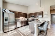 Thumbnail 1 of 13 - a kitchen with a large island and stainless steel appliances